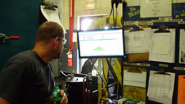 A shop floor operator at United Gear and Assembly using Synergy 2000 SPC Software. A photo of an operator at United Gear and Assembly using Synergy 2000 SPC Software.