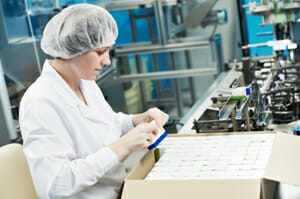 Operator ensuring items are within specification before shipping.